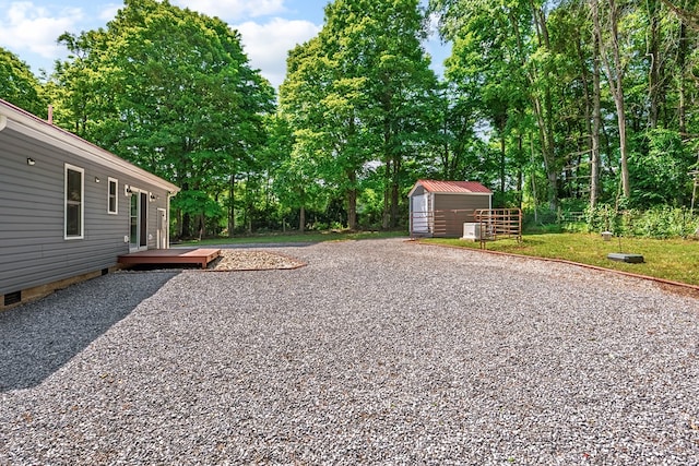 1610 Pope Rd, Ivanhoe, VA 24350 - view of yard with a storage unit, a wooden deck, and view of wooded area