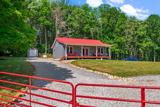 1610 Pope Rd, Ivanhoe, VA 24350 - ranch-style house with a porch, a metal roof, and a storage shed