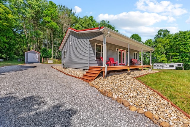 1610 Pope Rd, Ivanhoe, VA 24350 - view of front facade with a storage unit, covered porch, crawl space, a front yard, and driveway