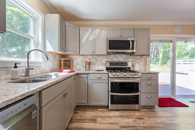 1610 Pope Rd, Ivanhoe, VA 24350 - kitchen with stainless steel appliances, gray cabinets, crown molding, tasteful backsplash, and light stone countertops