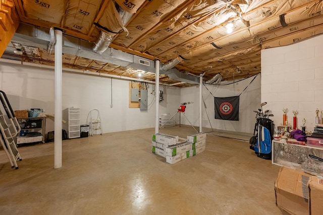 unfinished basement with concrete block wall and electric panel