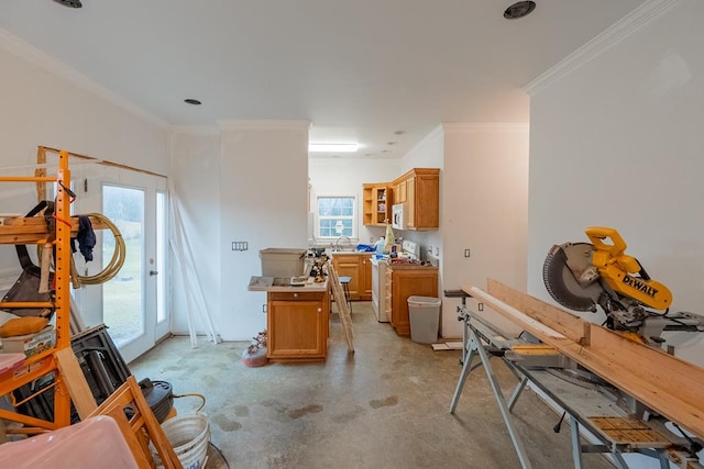 interior space featuring concrete flooring, ornamental molding, brown cabinets, gas range, and glass insert cabinets