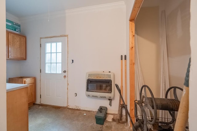 doorway to outside with crown molding, concrete floors, and heating unit