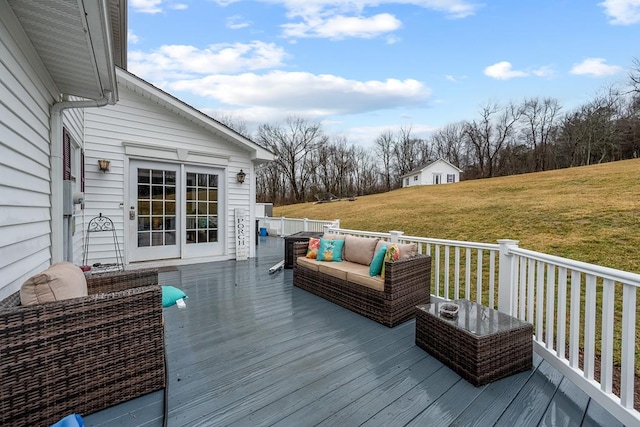 wooden deck featuring a lawn and an outdoor living space