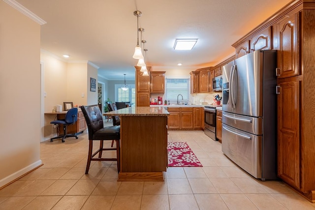 kitchen with light tile patterned floors, a breakfast bar area, a kitchen island, ornamental molding, and appliances with stainless steel finishes