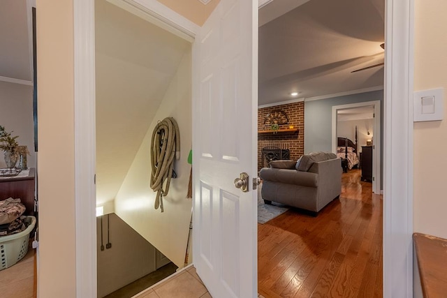 hall with ornamental molding and hardwood / wood-style floors