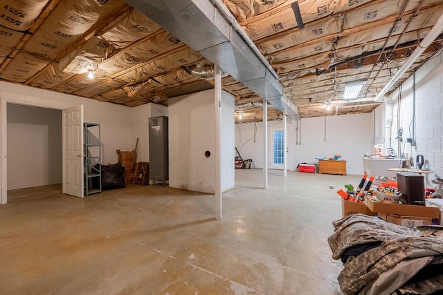 below grade area featuring concrete block wall and a healthy amount of sunlight