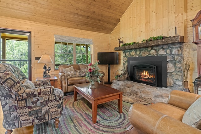 558 Pops Peak Rd, Fancy Gap, VA 24328 - living area with vaulted ceiling, wooden walls, a stone fireplace, and wooden ceiling