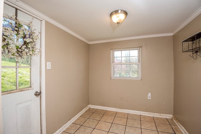 empty room featuring light tile patterned floors, baseboards, and ornamental molding