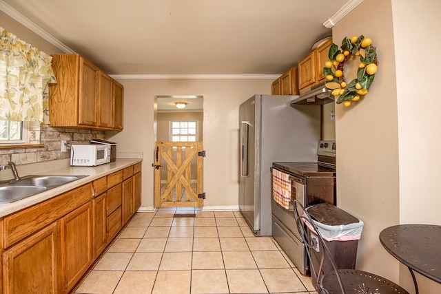 kitchen with tasteful backsplash, a sink, brown cabinetry, stainless steel electric range oven, and white microwave