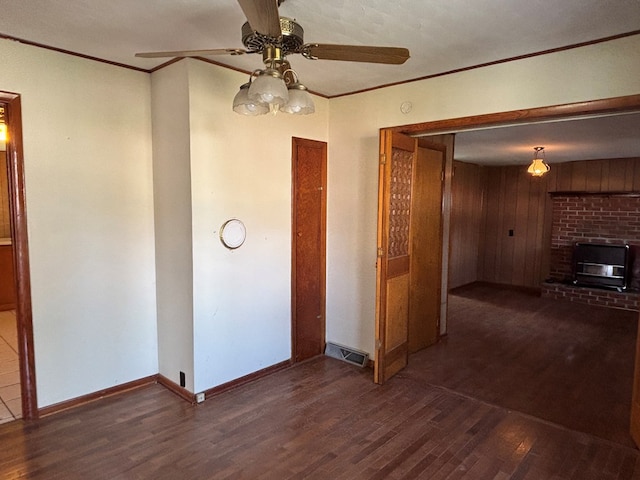 4127 Steelsburg Hwy, Cedar Bluff, VA 24609 - unfurnished living room featuring wood finished floors, ceiling fan, baseboards, a fireplace, and crown molding