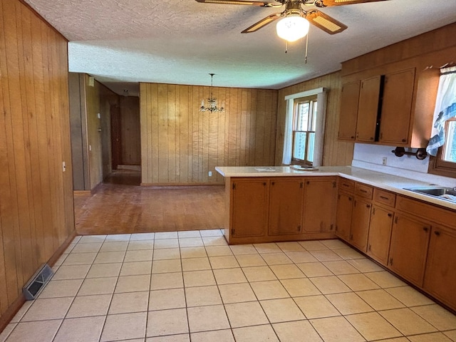 4127 Steelsburg Hwy, Cedar Bluff, VA 24609 - kitchen with wooden walls, light countertops, plenty of natural light, a sink, and ceiling fan