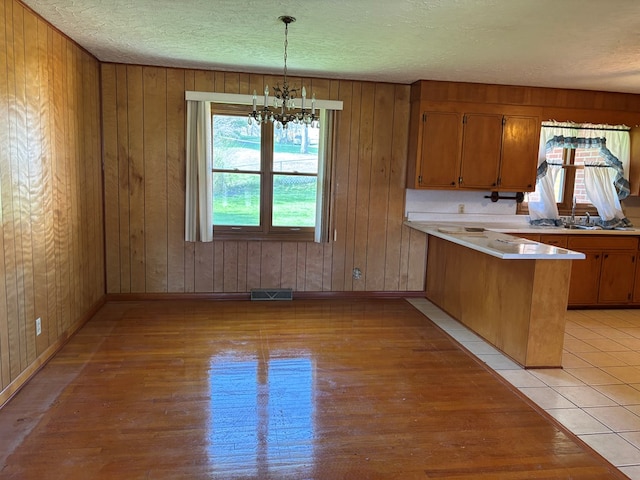 4127 Steelsburg Hwy, Cedar Bluff, VA 24609 - kitchen with a peninsula, light countertops, plenty of natural light, a chandelier, and a textured ceiling