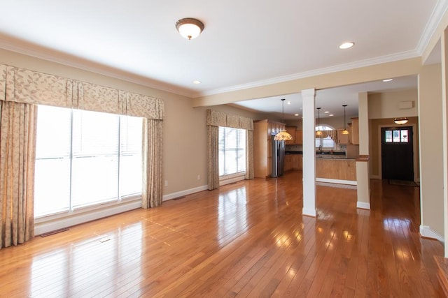 16084 Old Jonesboro Rd, Bristol, VA 24202 - unfurnished living room with light wood-type flooring, ornate columns, crown molding, and recessed lighting