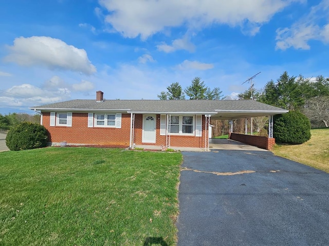 single story home with a carport, a chimney, aphalt driveway, brick siding, and a front lawn