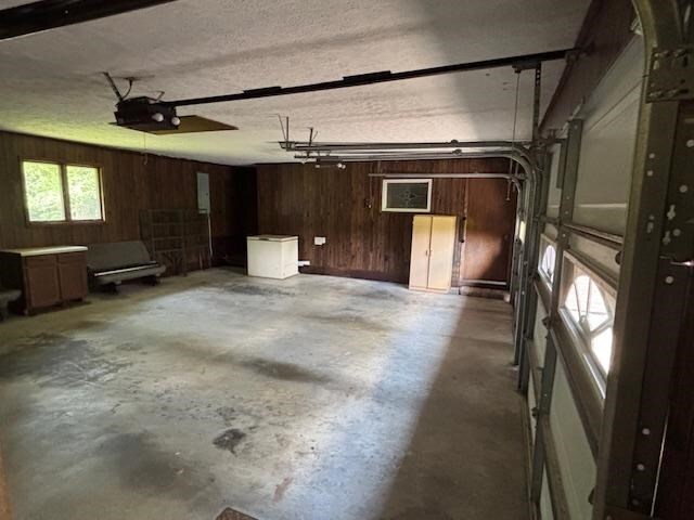 319 Bogey Dr, Abingdon, VA 24211 - garage with wooden walls and a garage door opener