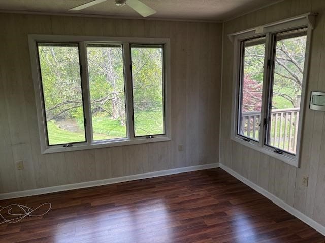 319 Bogey Dr, Abingdon, VA 24211 - empty room with dark wood-type flooring, a ceiling fan, and wooden walls
