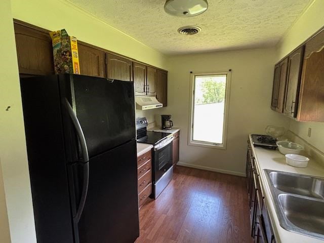319 Bogey Dr, Abingdon, VA 24211 - kitchen with freestanding refrigerator, electric stove, a textured ceiling, dark wood-style flooring, and light countertops