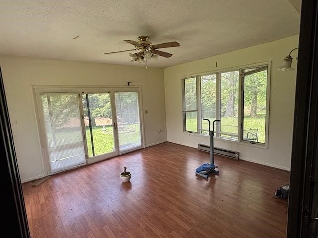 319 Bogey Dr, Abingdon, VA 24211 - workout area featuring plenty of natural light, a ceiling fan, baseboard heating, wood finished floors, and a textured ceiling