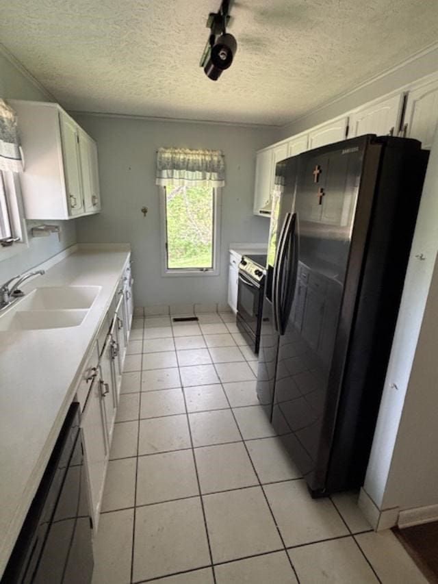 319 Bogey Dr, Abingdon, VA 24211 - kitchen featuring black appliances, white cabinetry, light tile patterned floors, and a textured ceiling