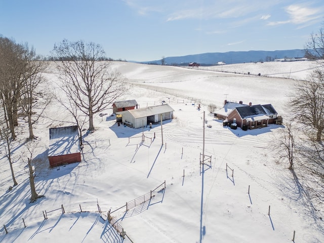 snowy aerial view featuring a mountain view