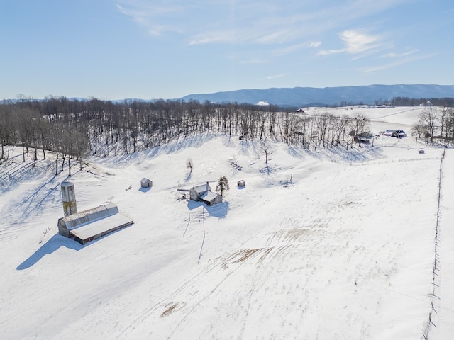 snowy aerial view featuring a mountain view