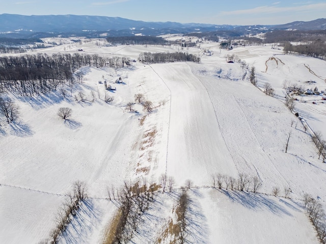 snowy aerial view with a mountain view