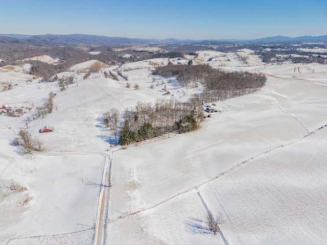 snowy aerial view featuring a mountain view