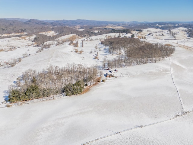 snowy aerial view with a mountain view