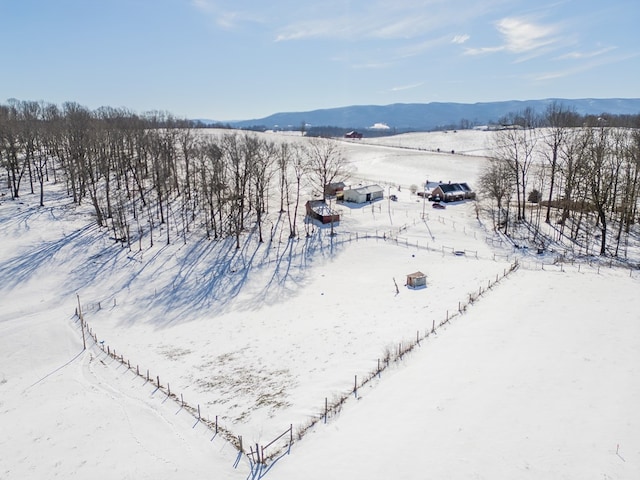 snowy aerial view featuring a mountain view