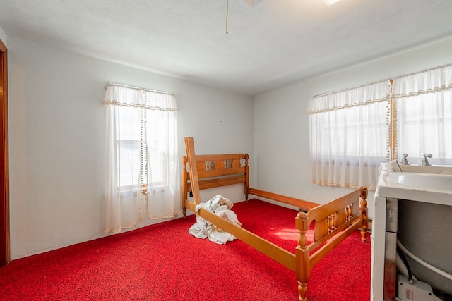 carpeted bedroom featuring a textured ceiling