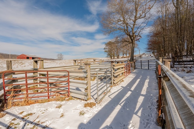 snowy yard with a rural view