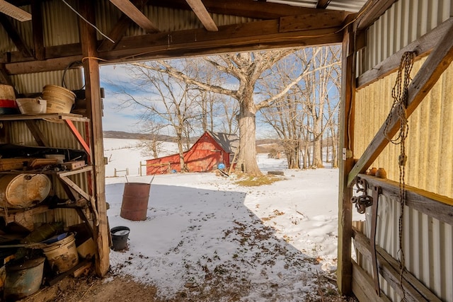 yard covered in snow with an outbuilding