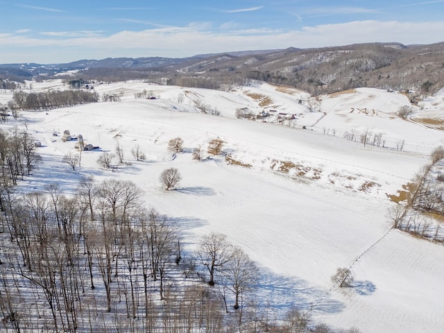 snowy aerial view with a mountain view