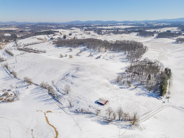 snowy aerial view with a mountain view