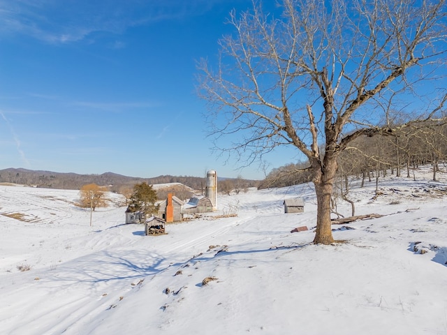 snowy yard featuring a mountain view