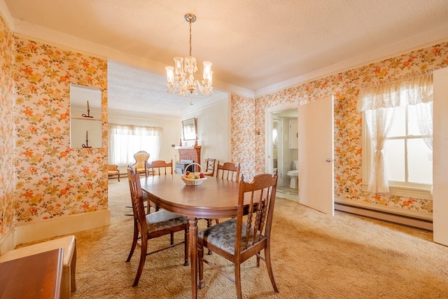 carpeted dining area featuring crown molding, a chandelier, a textured ceiling, and baseboard heating