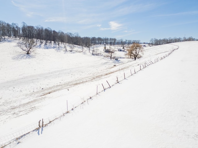 snowy aerial view featuring a rural view