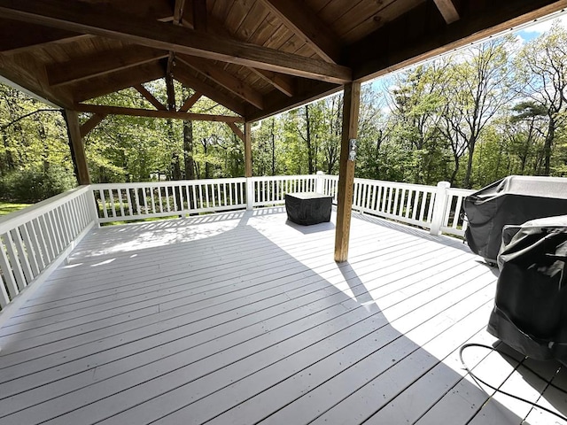 wooden terrace featuring view of scattered trees