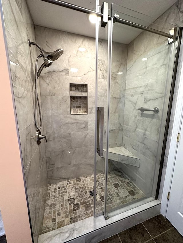 full bath with a stall shower and tile patterned flooring