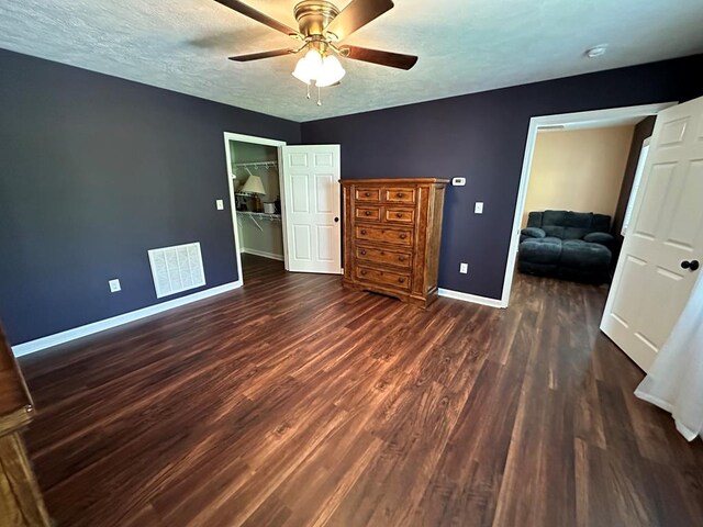 185 Laurel Dr, Fancy Gap, VA 24328 - bedroom with baseboards, dark wood-style flooring, ceiling fan, and a textured ceiling