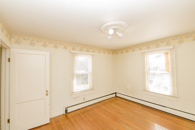 unfurnished room with hardwood / wood-style flooring