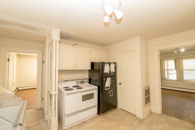 kitchen featuring white cabinetry, a baseboard heating unit, range with two ovens, and black fridge