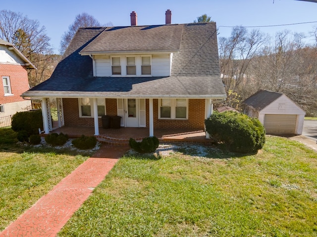 bungalow-style home with a garage, an outdoor structure, a front yard, and a porch