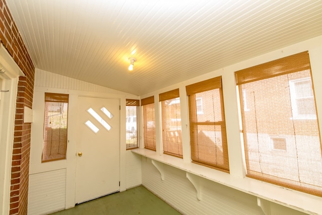 unfurnished sunroom with lofted ceiling