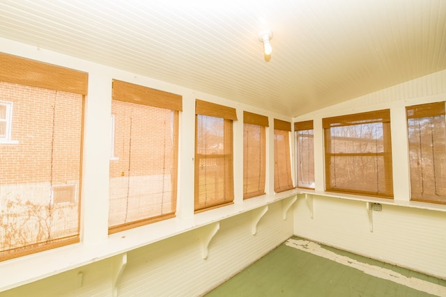 unfurnished sunroom featuring lofted ceiling