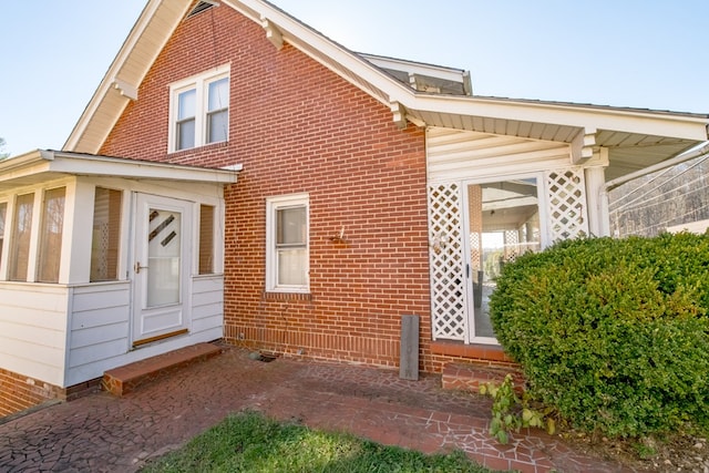 view of property exterior with a sunroom