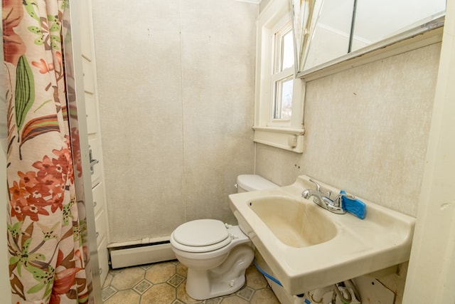 bathroom with a baseboard radiator, toilet, and tile patterned flooring