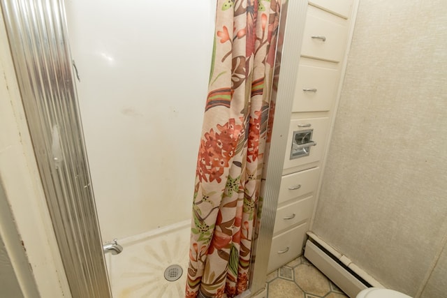 bathroom featuring a baseboard heating unit and curtained shower