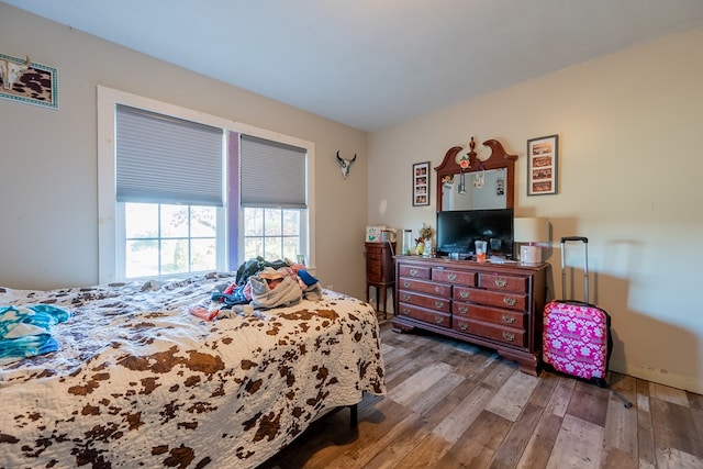 bedroom with dark wood-type flooring